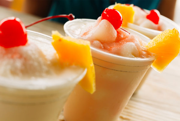 Image of pina coladas garnished with pineapple slices and cherries. Photo courtesy of Visit Puerto Rico.