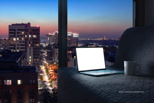 Marriott joins Internet Watch Foundation. This is an image of a laptop with a blank screen sitting on a couch in a hotel room at night. Image courtesy of Marriott International.