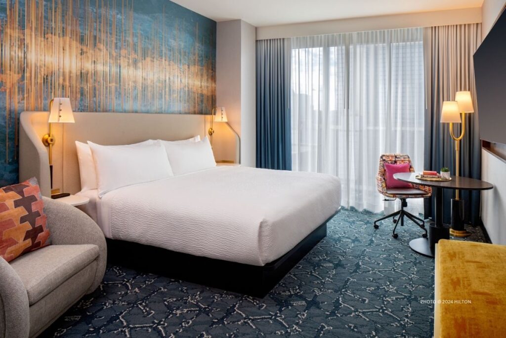 This is an image of a Standard King Guestroom at Tempo by Hilton Nashville Downtown, which opened February 15, 2024 in Nashville, Tennessee. Photo © 2024 Hilton.
