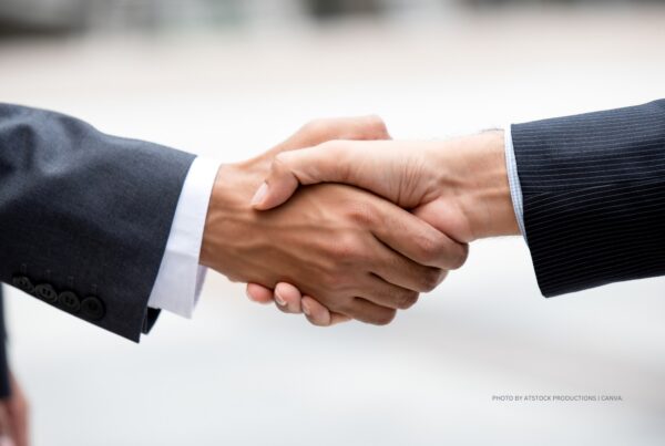 This is a stock image showing the forearms and hands of two businessmen shaking hands. Photo by Atstock Productions | Canva.
