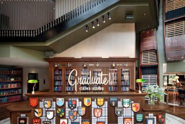 This is an image of the front desk at Graduate Hotel Cambridge, UK. It accompanies a press release announcing agreement for Hilton to acquire the Graduate Hotels brand in Q2 2024. Photo courtesy of Graduate Hotels.