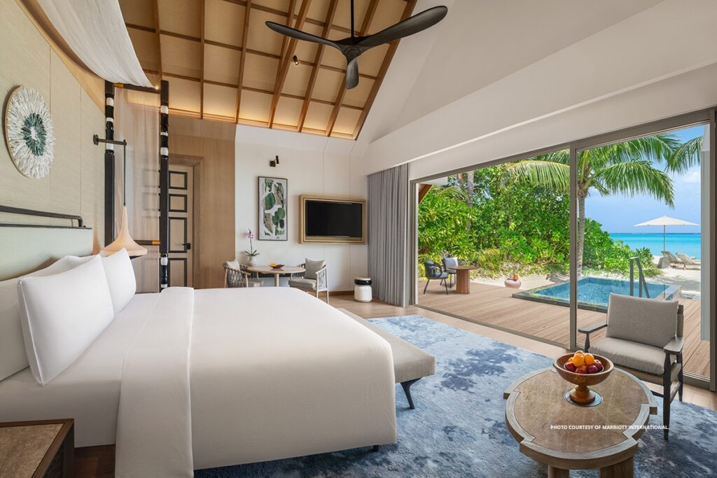 This is an image of the bedroom and deck of a beachfront villa with pool at JW Marriott Kaafu Atoll Island Resort in the Maldives. Photo courtesy of Marriott International.