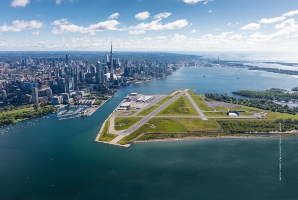 This image is an aerial view of Billy Bishop Toronto City Airport with the Toronto Skyline in background and Lake Ontario. Photo is courtesy of Billy Bishop Toronto City Airport.