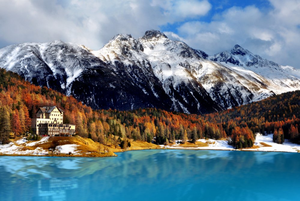 Idyllic lake surrounded by colorful trees in the Swiss Alps. St. Moritz.