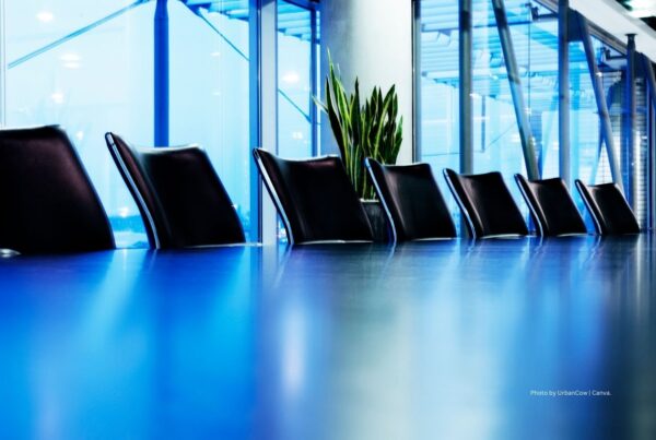 Board of Trustees and Executive Committee officers for 2023 announced by Incentive Research Foundation. This image shows a row of black chairs and blue boardroom table with windows and one green snake plant in background. Photo by UrbanCow | Canva.