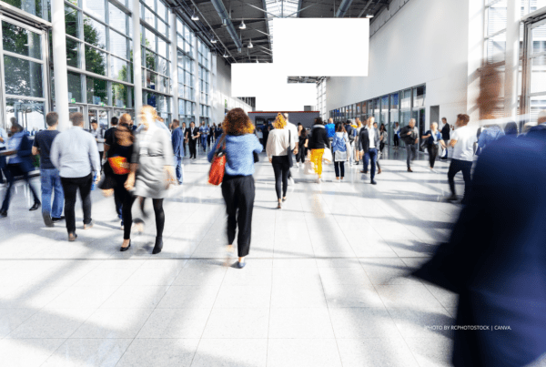 Costs, sustainability, higher attendance are some of the issues looked at in GDP's new survey of the MICE industry. This is a stock image of people walking through the concourse of a convention/conference centre. Photo by rcphotostock | Canva.