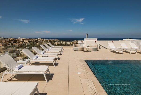 AC Hotel by Marriott St. Julian's opened in May 2023. It is the brand's first property on the island of Malta. This image shows lounge chairs and part of the pool on the hotel's rooftop terrace. Photo courtesy of Marriott International.