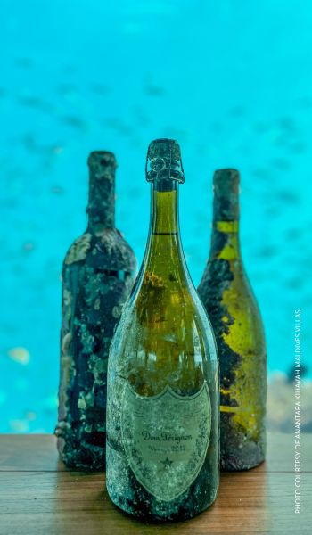 An underwater-aged wine tasting experience is now available at Anantara Kihavah Maldives Villas. This photo shows three bottles of underwater-aged wine available at the resort. Photo courtesy of Anantara Kihavah.