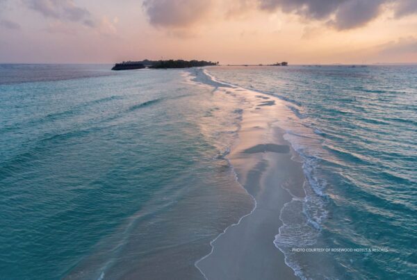 Rosewood Ranfaru will open in The Maldives in 2027. The luxury resort will have 120 rooms. This image is a beauty shot of one of the islands in The Maldives at sunset. Photo courtesy of Rosewood Hotels & Resorts.