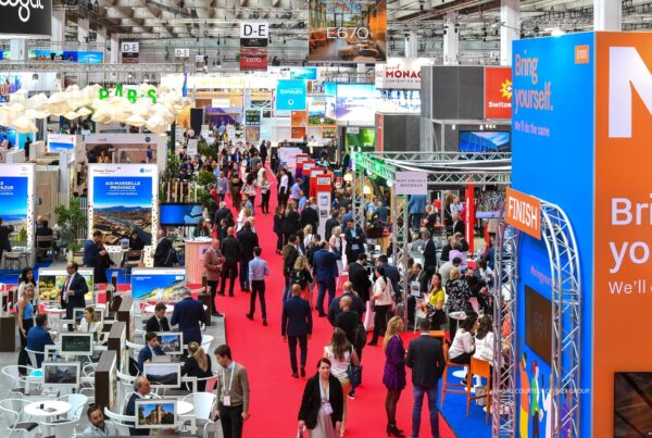 This is an image of an aisle on the show floor of IMEX Frankfurt 2023 with exhibit booths and crowds of attendees. Photo is courtesy of IMEX.