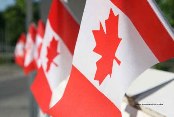 This is an image of a row of Canadian flags used as art with a press release about Destination Canada's launch of a fund to attract international events. Photo by Oliver Childs | Canva.