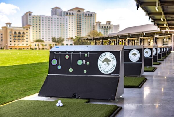 Eagles Edge is the newest venue at Omni Orlando Resort at ChampionsGate in Orlando, Florida. This image shows some of the venue's hitting bays with the hotel in the background. Photo courtesy of Omni Hotels & Resorts.