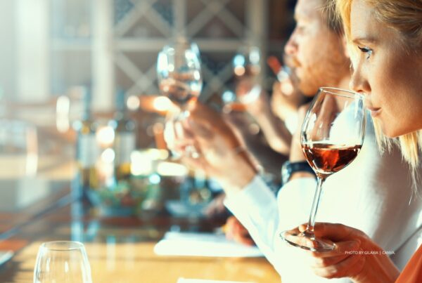 This is a stock photo by a group of people doing a wine tasting. Photo by gilaxia | Canva.