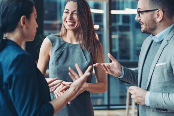 This is a stock image of businesspeople networking at an event. Photo by pixelfit | Canva.