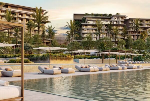 This image is a rendering of a pool and buildings planned for Rosewood Dubai, opening 2029. Rendering courtesy of Rosewood Hotels & Resorts.