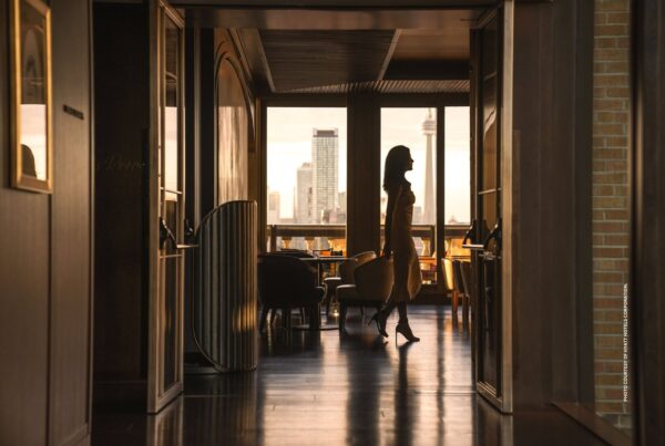 This image shows a woman walking through the Writers Room Bar in the Park Hyatt Toronto. Photo courtesy of Hyatt Hotels Corporation.