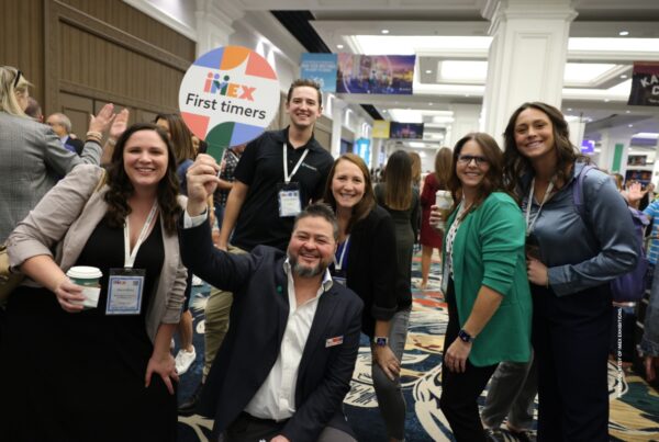 This is an image of David Kries (center, front), Senior Hosted Relationship Manager, IMEX, with first time attendees at previous edition of the show. Photo courtesy of IMEX Exhibitions.