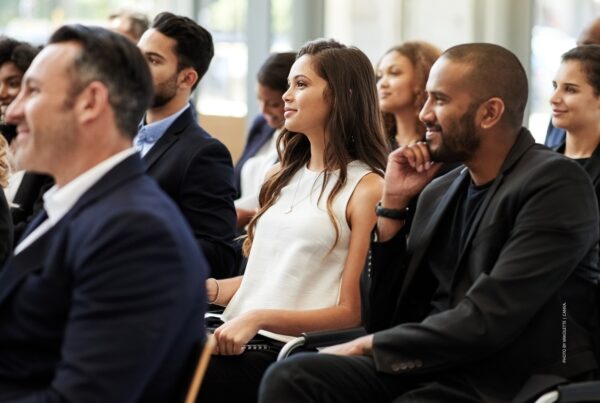 This is a stock image of attendees at a business event. Photo by Mikolette | Canva.